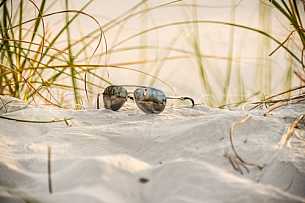 Sunglasses in the sand at the beach